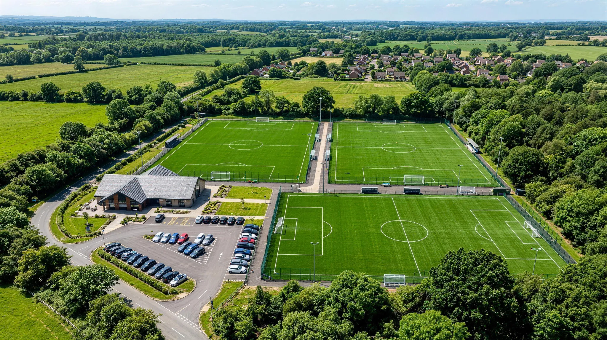 An aerial view of two full-size 3G pitches beside a clubhouse and car park